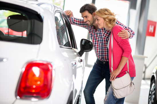 photodune 13717648 young couple chooses to buy a car